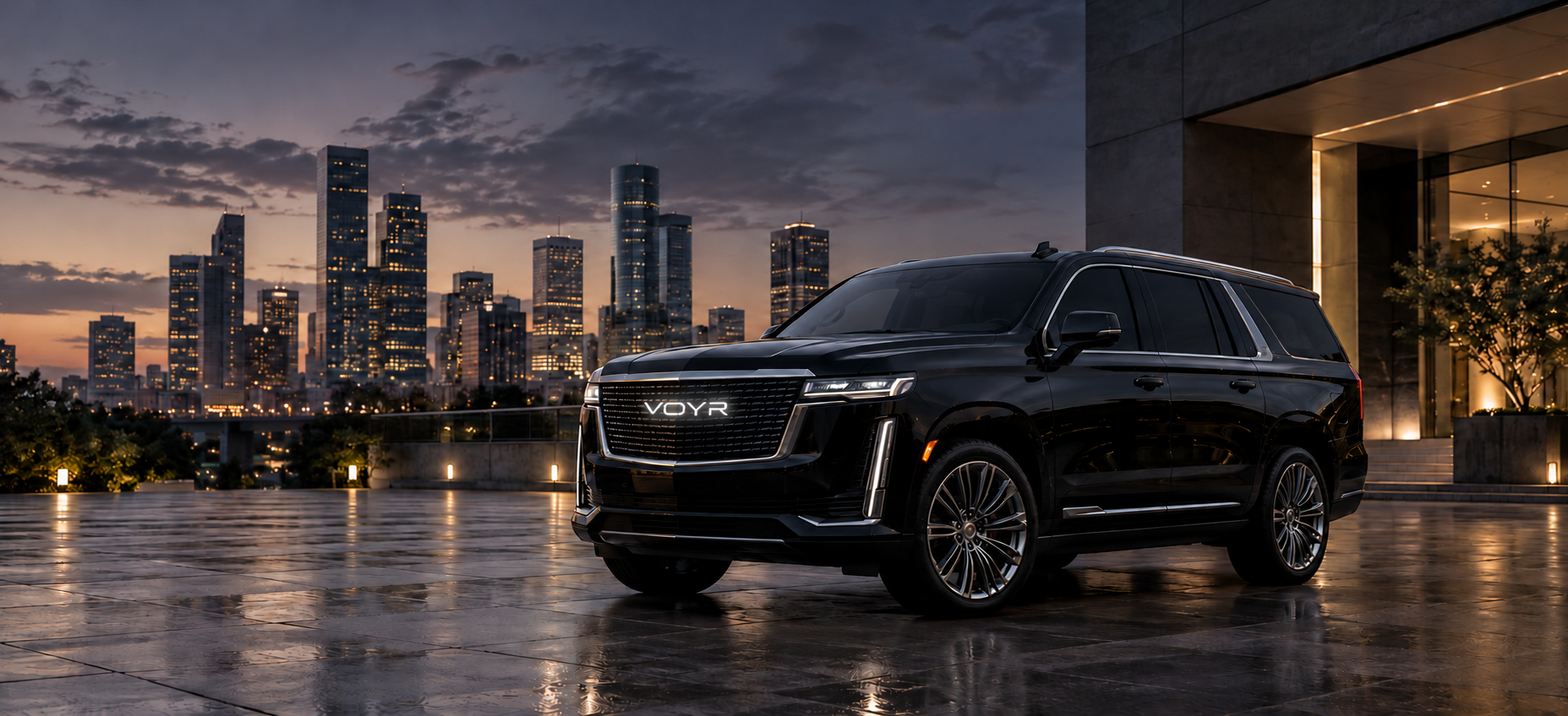 Black luxury SUV with an illuminated VOYR grille emblem in a Houston city setting
